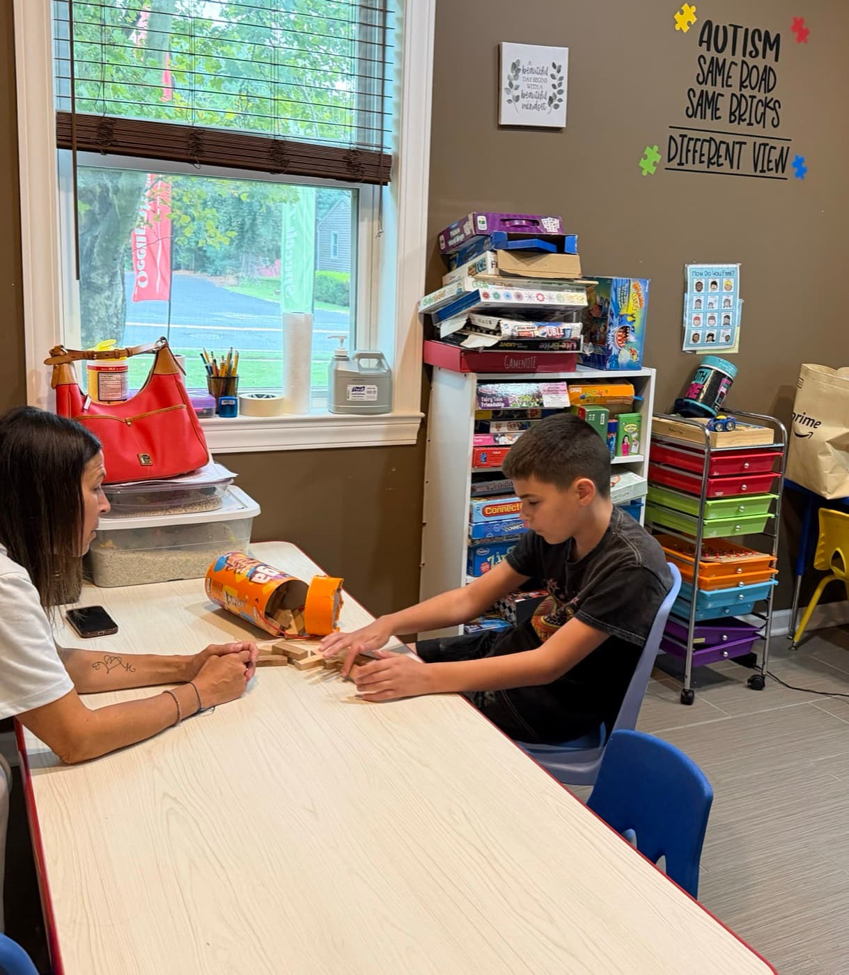 A therapist and child building fine-motor skills