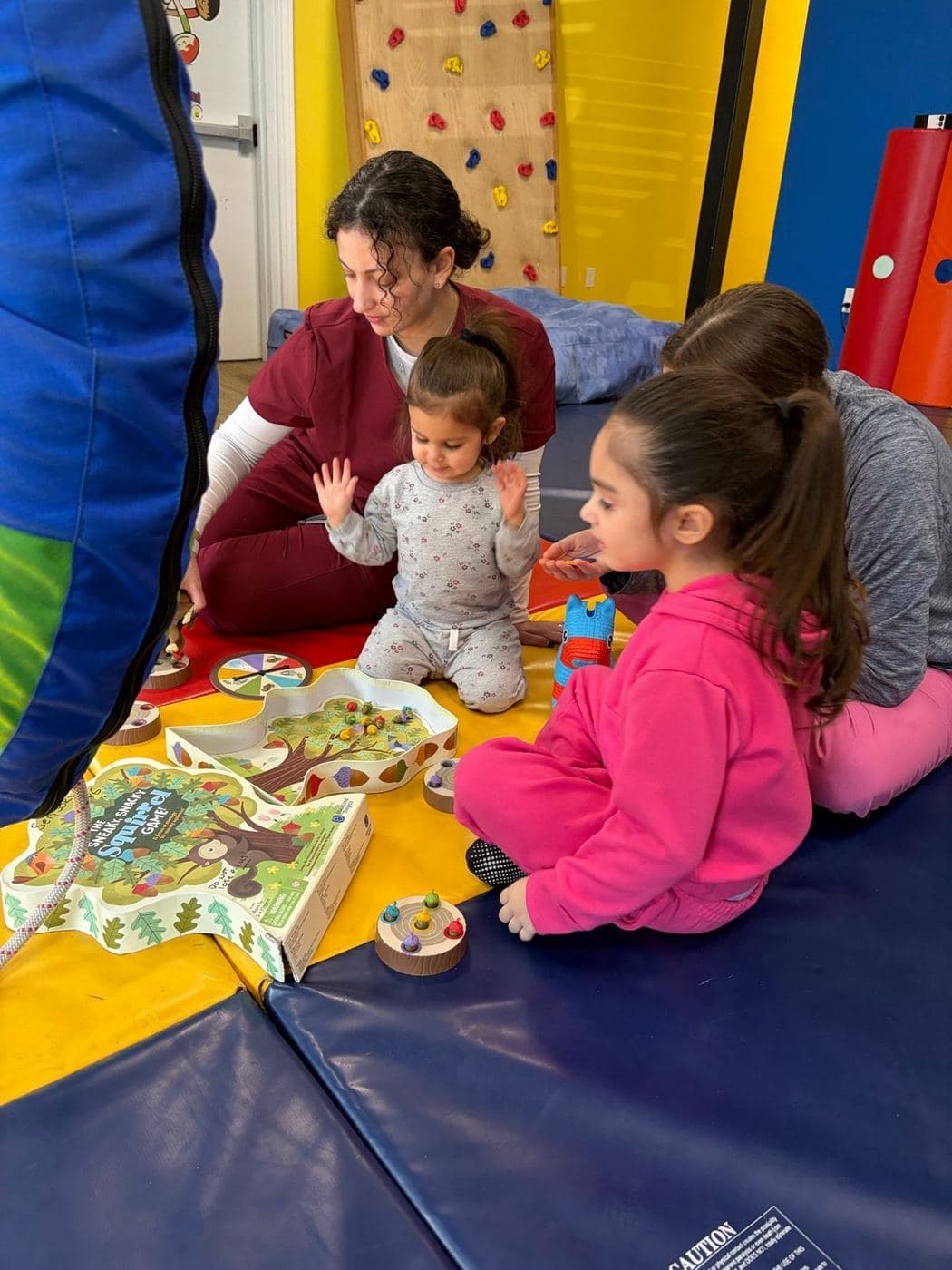 A therapist and children playing a board game together